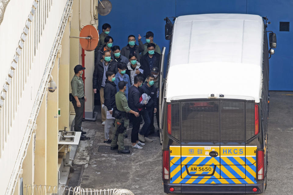 In this March 2, 2021, file photo, some of the 47 democracy activists are escorted by Correctional Services officers in Hong Kong. A national security law enacted in 2020 and COVID-19 restrictions have stifled major protests in Hong Kong including an annual march on July 1. (AP Photo/Kin Cheung, File)