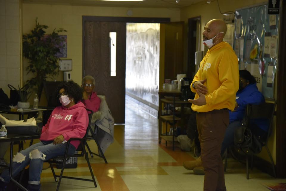 Damon Brown, co-founder of the nonprofit RISE Corp., breaks down the Ring doorbell distribution program to a group of canvassers inside Washington Heights United Methodist Church in Battle Creek, Mich. on Friday, Jan. 21, 2022.