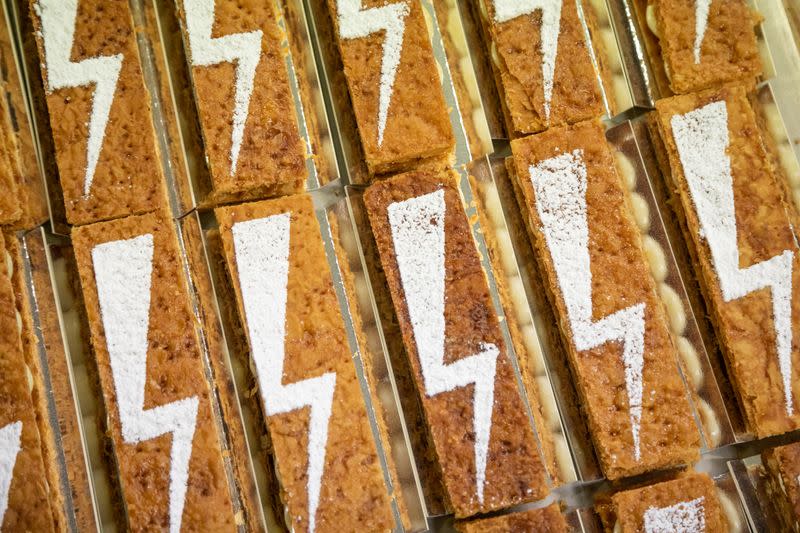 A baker prepares pastry with a bolt sign as a ubiquitous symbol of the protests sweeping across Poland