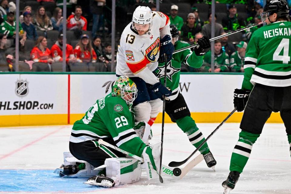 Mar 12, 2024; Dallas, Texas, USA; Dallas Stars goaltender Jake Oettinger (29) makes a stick save as Florida Panthers center Sam Reinhart (13) looks for the loose puck during the first period at the American Airlines Center.