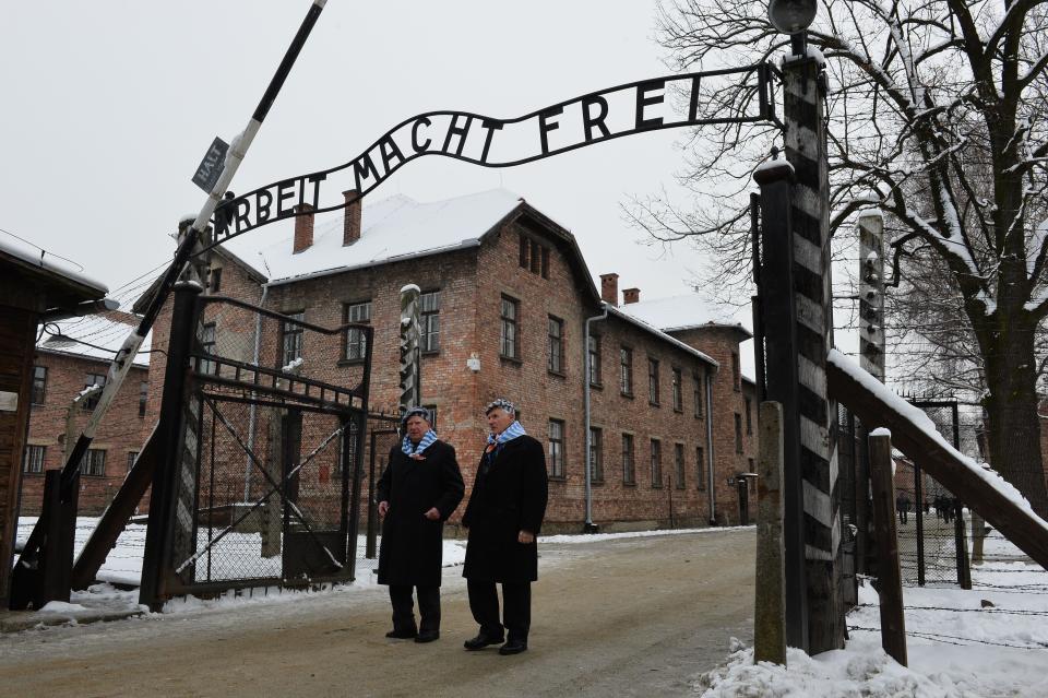 Auschwitz survivors walk through the gate of the former Auschwitz concentration camp as they arrive to attend fesitivities to mark the 70th anniversary of the camp's liberation on January 27, 2015 at the Auschwitz-Birkenau memorial site in Oswiecim, Poland. Seventy years after the liberation of Auschwitz, ageing survivors and dignitaries gather at the site synonymous with the Holocaust to honour victims and sound the alarm over a fresh wave of anti-Semitism. 