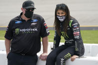 Hailie Deegan, right, talks to a crew member prior to the start of the NASCAR Truck Series auto race at Richmond International Raceway in Richmond, Va., Saturday, April 17, 2021. (AP Photo/Steve Helber)