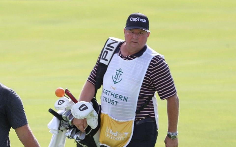 caddie Eric Larson walk the 14th hole during the first round of THE NORTHERN TRUST, the first event of the FedExCup Playoffs, at Liberty National Golf Club on August 19, 2021 in Jersey City, New Jersey - Reformed drug dealer fulfils dream to caddie for Team USA in Ryder Cup in home state - GETTY IMAGES