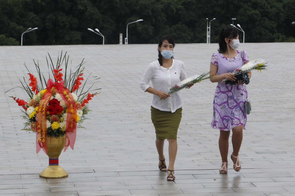 People visit the statues of former North Korean leaders Kim Il Sung and Kim Jong Il to lay flowers on the occasion of the 67th anniversary of the end of the Korean War, which the country celebrates as the day of "victory in the fatherland liberation war" in Pyongyang, Monday, July 27, 2020. (AP Photo/Jon Chol Jin)