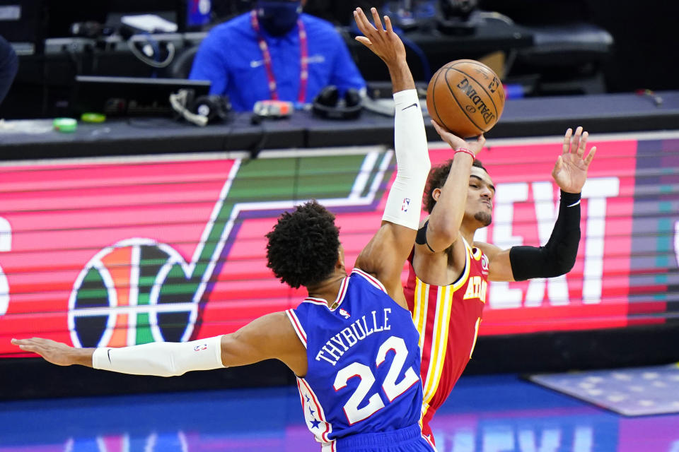 FILE - In this June 16, 2021, file photo, Atlanta Hawks' Trae Young, right, is fouled by Philadelphia 76ers' Matisse Thybulle during the second half of Game 5 in a second-round NBA basketball playoff series in Philadelphia. Players like Atlanta’s Trae Young will have a tougher time drawing foul calls this season, with the NBA cracking down on non-basketball moves offensive players used to make to create contact with defenders. (AP Photo/Matt Slocum, File)