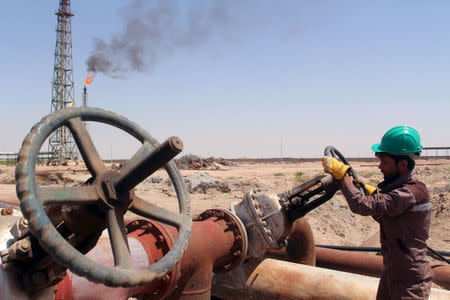 A worker checks the valve of an oil pipe at Al-Sheiba oil refinery in the southern Iraq city of Basra, April 17, 2016. REUTERS/Essam Al-Sudani