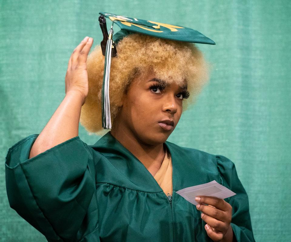 Graduate Gwendolyn Madison adjusts her hair and cap before the Burncoat High School graduation on Monday.