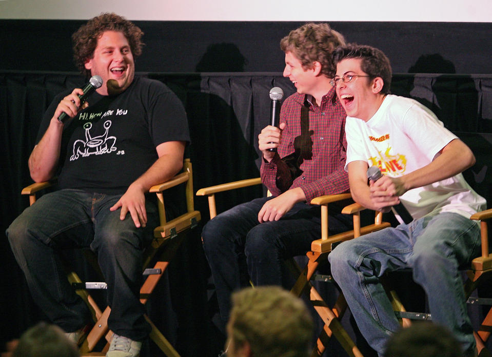 Jonah, Christopher and Michael laugh on stage at a screening