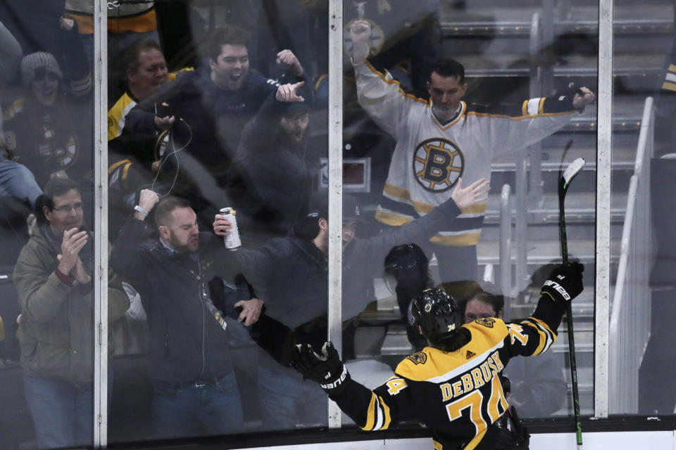 Boston Bruins left wing Jake DeBrusk (74) celebrates with fans after his game-tying goal against Vegas Golden Knights goaltender Marc-Andre Fleury during the third period of an NHL hockey game in Boston, Tuesday, Jan. 21, 2020. (AP Photo/Charles Krupa)