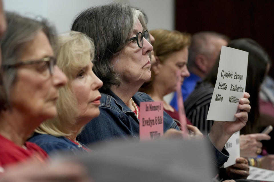 Linda McFadyen-Ketchum holds a sign with the names of the six victims of the Covenant School shooting in March of 2023 during a meeting of the House Criminal Justice Subcommittee, Tuesday, March 26, 2024, in Nashville, Tenn. (AP Photo/George Walker IV)