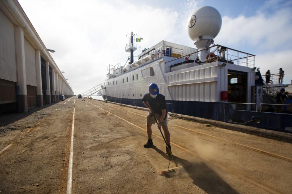 Jake Bonney, 23, sweeping between the Nautilus and a warehouse