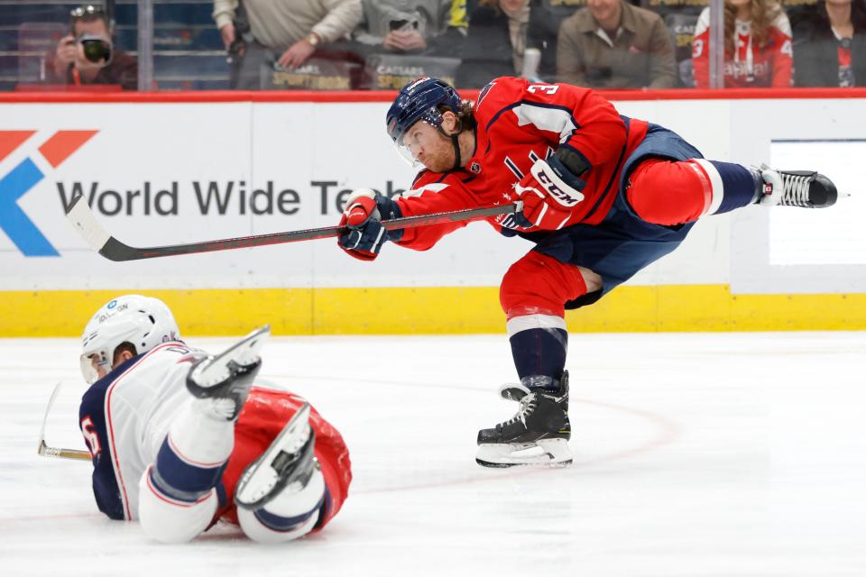 Feb 8, 2022; Washington, District of Columbia, USA; Washington Capitals defenseman Nick Jensen (3) shoots the puck as Columbus Blue Jackets center Jack Roslovic (96) defends during the first period at Capital One Arena. Mandatory Credit: Geoff Burke-USA TODAY Sports