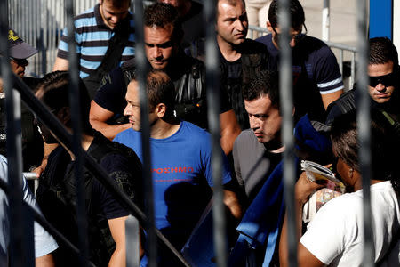 Two of the eight Turkish soldiers, who fled to Greece in a helicopter and requested political asylum after a failed military coup against the government, are escorted by special police forces after the postponement of their interviews for asylum request at the Asylum Service in Athens, Greece, July 27, 2016. REUTERS/Alkis Konstantinidis /File Photo