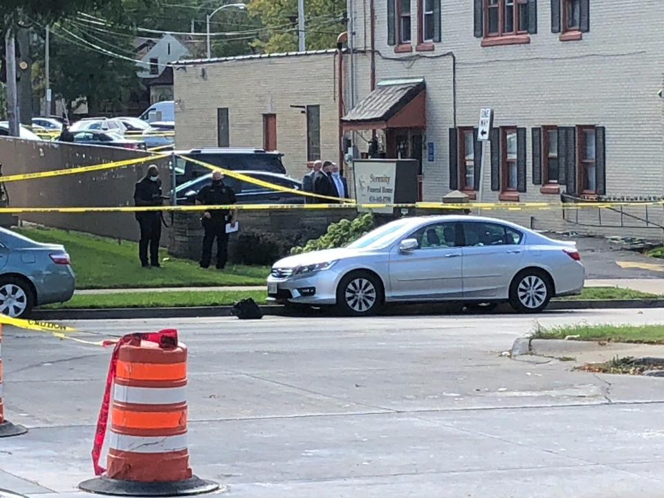 Investigators gather outside Serenity Funeral Home on West Fond du Lac Avenue in Milwaukee after seven people were injured in a shooting there Wednesday.