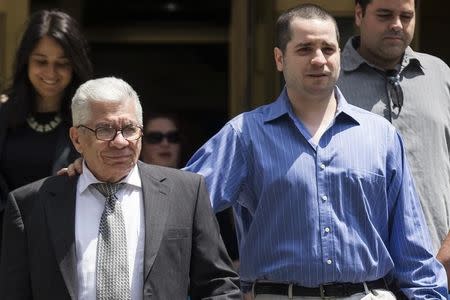 Former New York City police officer Gilberto Valle, dubbed by local media as the "Cannibal Cop," exits the U.S. District Court for the Southern District of New York in Lower Manhattan, with his father Gilberto, July 1, 2014. REUTERS/Brendan McDermid