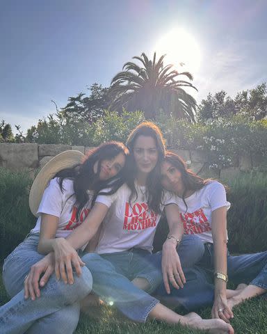 <p>Alliance of Moms/Instagram</p> Meghan Markle (right) models the Alliance of Mom's charitable new Love Like a Mother t-shirt with Kelly McKee Zajfen (center) and Abigail Spencer (left).