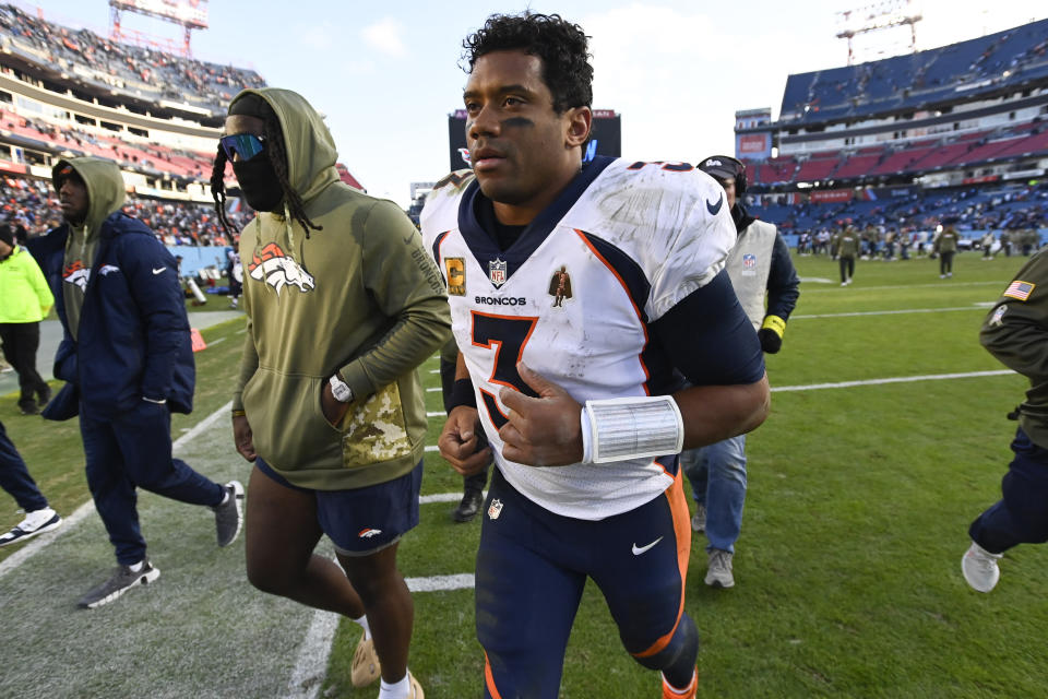 Denver Broncos quarterback Russell Wilson runs off the field after an NFL football game between the Tennessee Titans and the Denver Broncos, Sunday, Nov. 13, 2022, in Nashville, Tenn. The Tennessee Titans won 17-10. (AP Photo/Mark Zaleski)