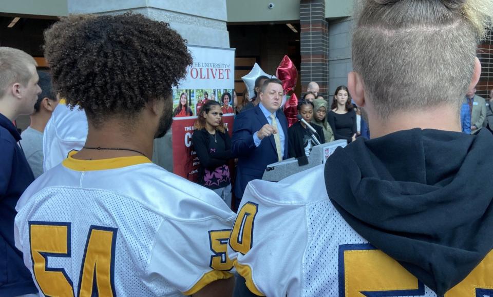 Justin Sheehan, executive director of Lansing Promise, talks at a podium at Eastern High School on Sept. 8, 2023, about a new University of Olivet program that automatically admits Lansing School District students.