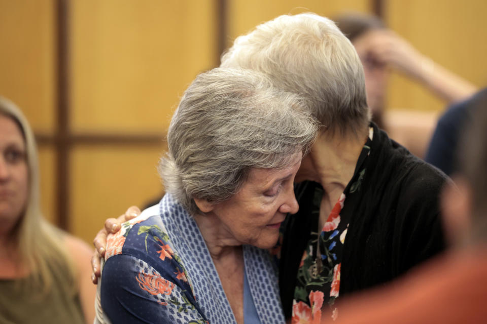 Family members of the victims embrace following the arraignment of Christopher Ferguson, Tuesday, June 27, 2023, at District Court in Newton, Mass. Ferguson, 41, pleaded not guilty and was ordered held without bail Tuesday in connection with a crime that has rattled a Boston suburb and a church community: the apparently random weekend killings of a couple celebrating their 50th wedding anniversary, along with the woman’s 97-year-old mother. (Craig F. Walker/The Boston Globe via AP, Pool)