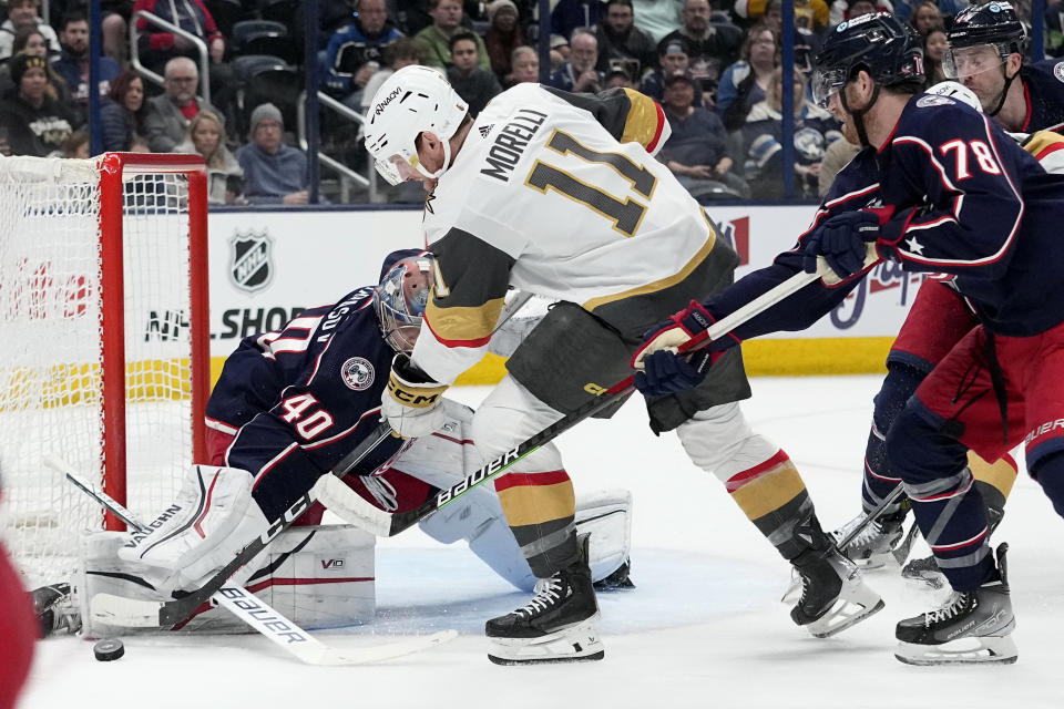 Vegas Golden Knights left wing Mason Morelli (11) shoots against Columbus Blue Jackets goaltender Daniil Tarasov (40) in front of Blue Jackets defenseman Damon Severson (78) in the first period of an NHL hockey game Monday, March 4, 2024, in Columbus, Ohio. (AP Photo/Sue Ogrocki)
