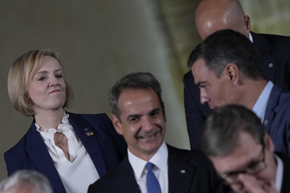 From left, British Prime Minister Liz Truss, Greece's Prime Minister Kyriakos Mitsotakis and Spain's Prime Minister Pedro Sanchez at a group photo during a meeting of the European Political Community at Prague Castle in Prague, Czech Republic, Thursday, Oct 6, 2022. Leaders from around 44 countries are gathering Thursday to launch a "European Political Community" aimed at boosting security and economic prosperity across the continent, with Russia the one major European power not invited. (AP Photo/Alastair Grant, Pool)