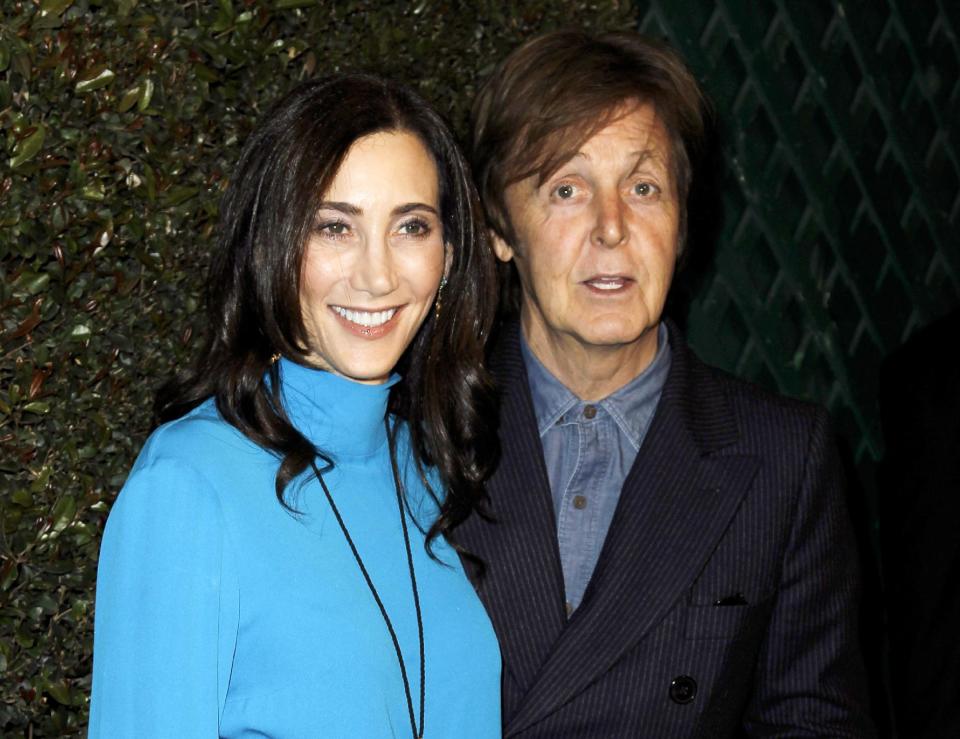 FILE - This April 13, 2012 file photo shows Paul McCartney, right, and his wife Nancy Shevell at the world premiere of the music video for McCartney's song, "My Valentine", in West Hollywood, Calif. Local media outlets report that the former Beatle accompanied his wife, Nancy Shevell, during her visit to the Syracuse, N.Y. area Wednesday, Sept. 5, for a business meeting at New England Motor Freight’s operations in suburban DeWitt. Shevell is the vice president of administration for the company owned by her father, Myron Shevell. The reports say McCartney and Nancy Shevell flew into Syracuse on a private jet and spent several hours in the area, including having lunch with company employees. Photos of McCartney with groups of workers have been posted on Facebook pages and Syracuse media websites. (AP Photo/Matt Sayles, file)