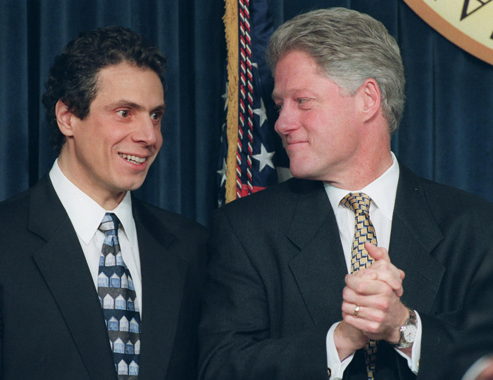 FILE — In this Dec. 20, 1996 file photo, Housing Secretary-designate Andrew Cuomo looks on as President Clinton applauds during a news conference in the Old Executive Office Building in Washington, where the president announced Cuomo's, and other selections, for his administration in his second term. Cuomo got his start in politics as his father's aide and campaign manager, before serving as U.S. housing secretary under Bill Clinton and state attorney general. (AP Photo/Denis Paquin File)