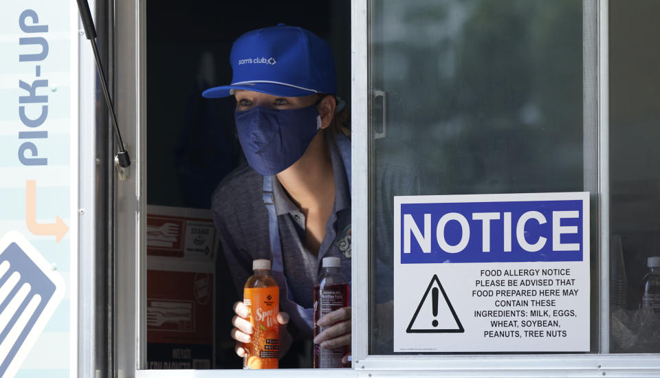 Tiffany Sawczenko stands ready to hand out free drink samples out of a food truck window Friday, June 18, 2021, in McKinney, Texas. When the pandemic was declared in March 2020, retailers worried about the potential spread of the coronavirus so they cut off free sampling of everything from food to makeup to toys. But now with vaccinations rolling out and the threat of COVID-19 easing in the U.S., food vendors and stores are feeling confident enough to revive the longstanding tradition. (AP Photo/LM Otero)