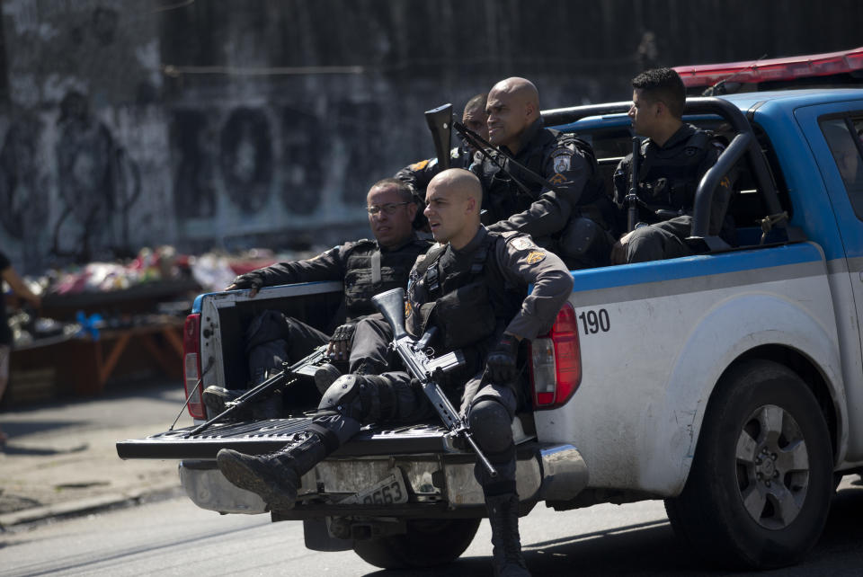 Police officers patrol the Complexo de Alemao slum during an operation in Rio de Janeiro, Brazil, Monday, Aug. 20, 2018. At least 11 people have been killed during shootouts involving military personnel and police in Rio on Monday. Since February, the military has been in charge of security in the state of Rio de Janeiro, which is struggling to curb a spike in violence. (AP Photo/Silvia Izquierdo)