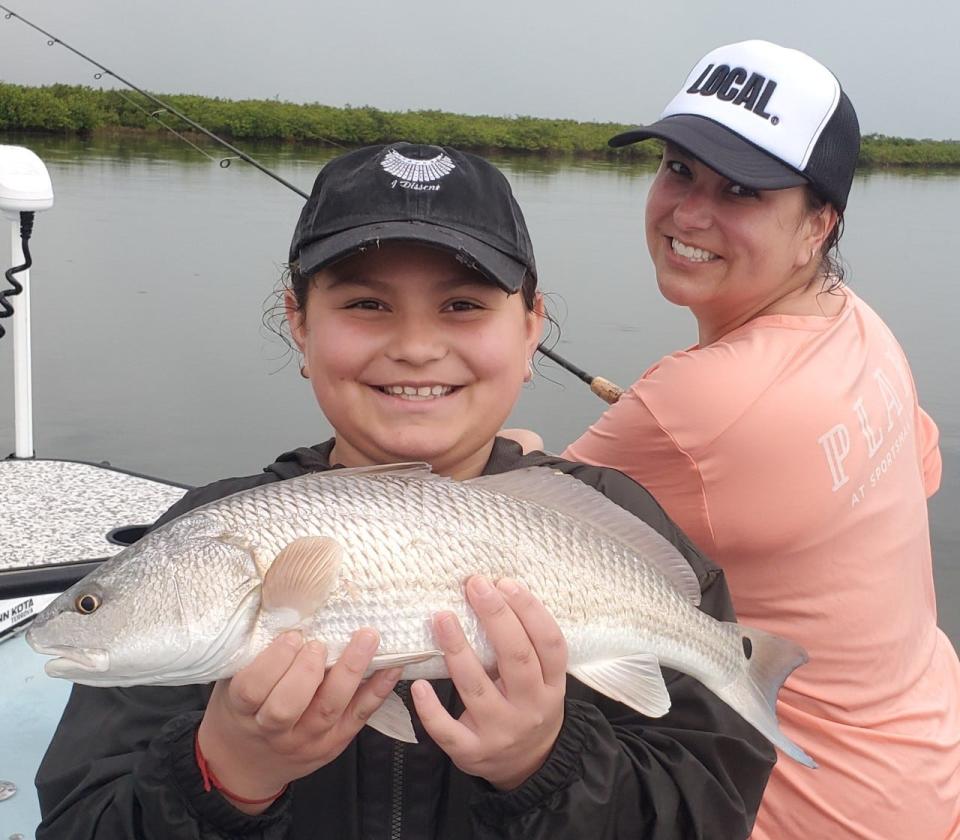 Isabella Geraldo, with her mom Ashley, showing off a nice redfish she brought aboard while fishing with local Capt. Blake O'Connor in the intracoastal.