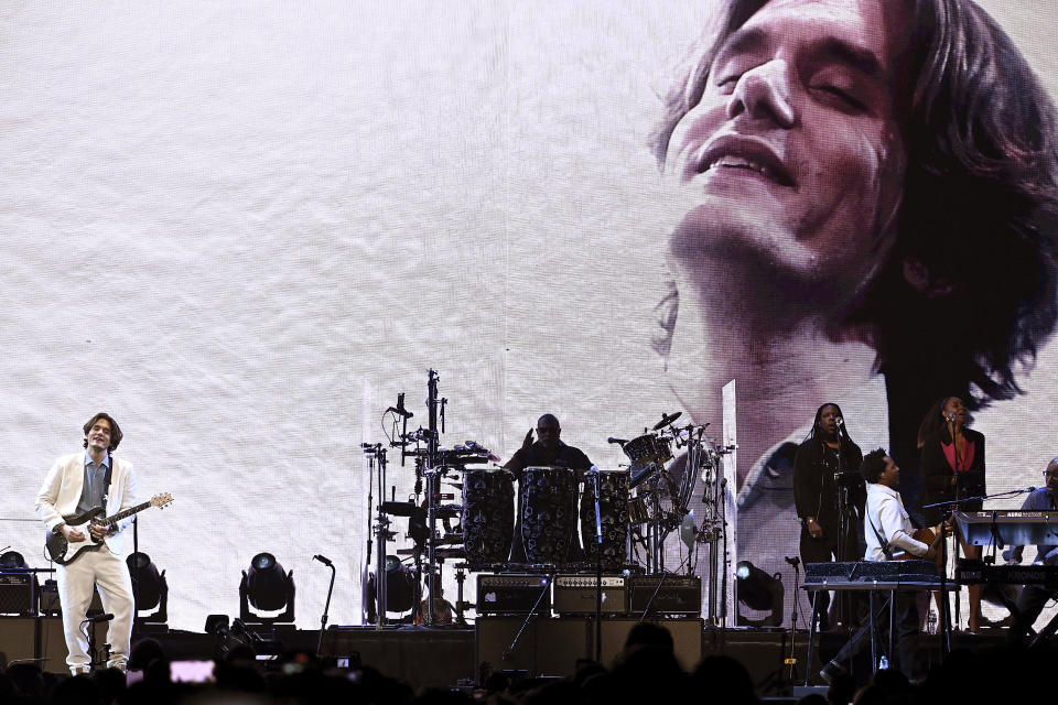 Musician John Mayer, left, performs at Madison Square Garden during his Sob Rock Tour on Sunday, Feb. 20, 2022, in New York. (Photo by Evan Agostini/Invision/AP)