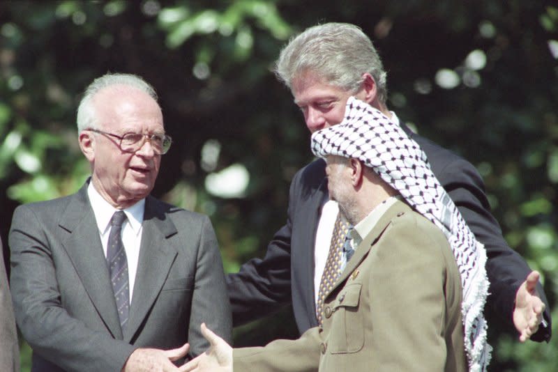 The historical handshake between Israeli Prime Minister Yithzak Rabin (L) and PLO Chairman Yasser Arafat (R) during peace accord signing ceremonies held on the South Lawn of the White House on September 13, 1993. On November 9, 1995, Arafat visited Israel for the first time to offer personal condolences to Rabin's widow. File Photo by Leighton Mark/UPI