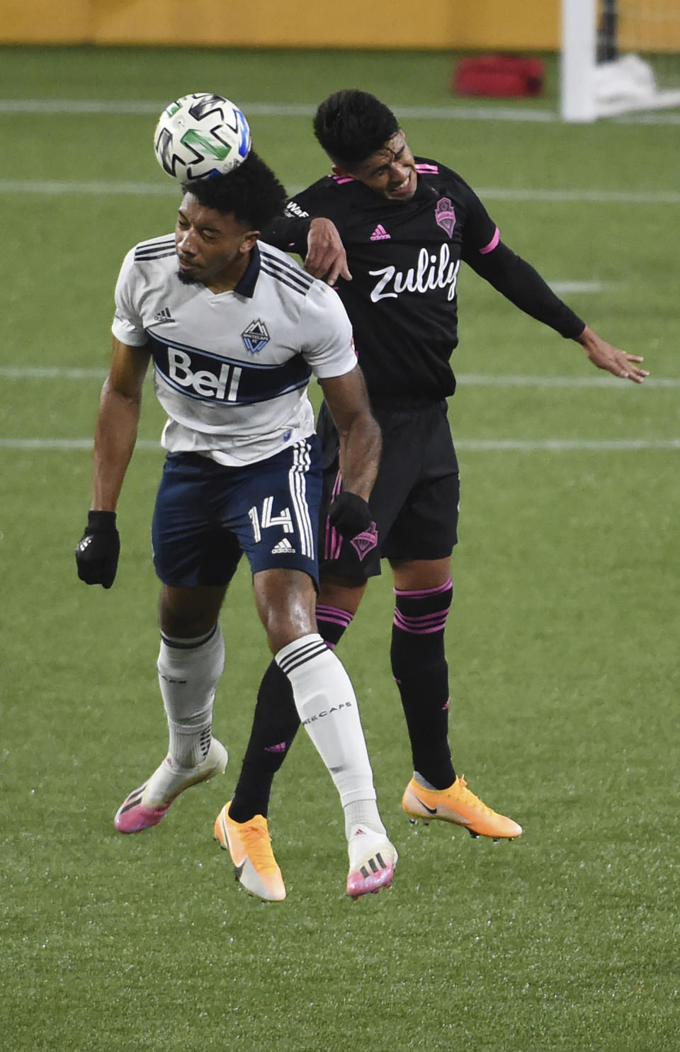 Vancouver Whitecaps forward Theo Bair, left, and Seattle Sounders defender Xavier Arreaga fo up for a head ball during the first half of an MLS soccer match in Portland, Ore., Tuesday, Oct. 27, 2020. (AP Photo/Steve Dykes)