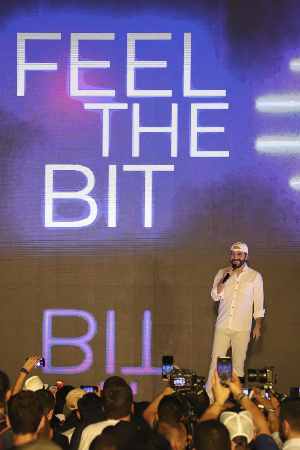 El Salvador's President Nayib Bukele participates in the closing ceremony of a congress for cryptocurrency investors in Santa Maria Mizata, El Salvador, Saturday, Nov. 20, 2021. Bukele announced during the rock concert-like atmosphere at the gathering that his government will build an oceanside "Bitcoin City" at the base of a volcano. (AP Photo/Salvador Melendez)