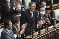 Yoshihide Suga stands up after being elected as Japan's new prime minister at parliament's lower house in Tokyo, Wednesday, Sept. 16, 2020. Suga was formally elected Wednesday as Japan’s new prime minister in a parliamentary vote, replacing Shinzo Abe. (AP Photo/Koji Sasahara)