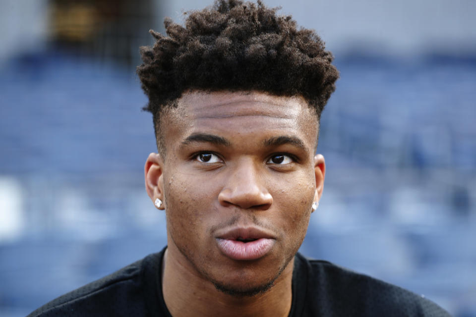 FILE - In this July 15, 2019, file photo, Milwaukee Bucks' Giannis Antetokounmpo speaks to reporters at batting practice before a baseball game between the New York Yankees and the Tampa Bay Rays, in New York. This season’s NBA MVP has won the award before. A trio of past winners of the award — reigning MVP Giannis Antetokounmpo of the Milwaukee Bucks, four-time MVP LeBron James of the Los Angeles Lakers and 2017-18 winner James Harden of the Houston Rockets — were announced Saturday, Aug. 8, 2020, as the finalists for this season’s top NBA individual honor. (AP Photo/Kathy Willens, File)