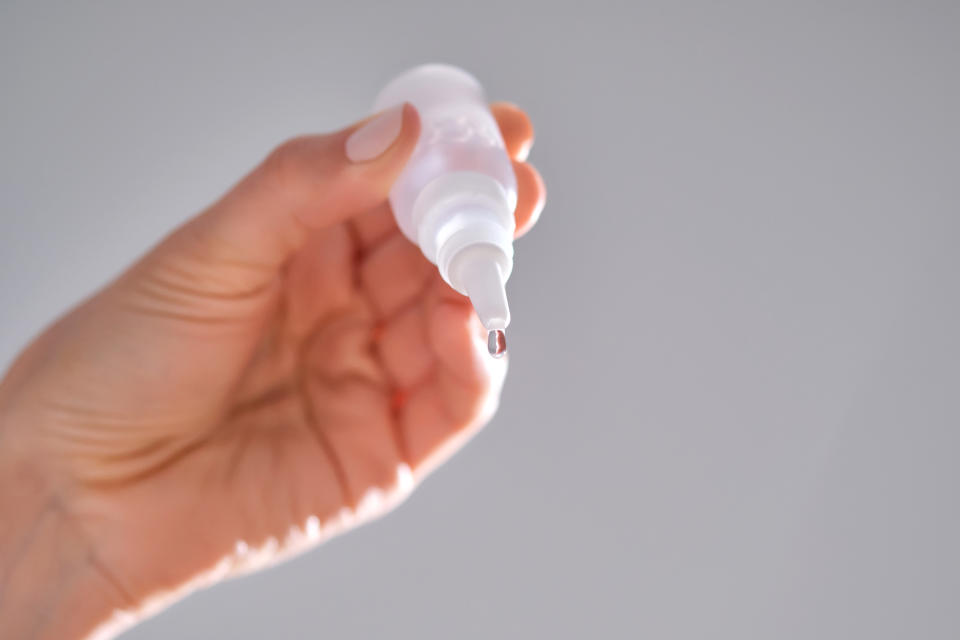 A TikTok user went viral for using eye drops to conceal acne. But is it safe? (Photo via Getty Images)