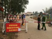 Police wearing masks guard a road checkpoint before entering the Son Loi commune in Vinh Phuc province, Vietnam, on Thursday, Feb. 13, 2020. 0fficial media reported that the Son Loi commune with 10,000 residents northwest of the capital Hanoi was put in lockdown due to a cluster of cases of the COVID-19 disease there. Vietnam has confirmed 16 cases of the disease. (AP Photo/Yves Dam Van)