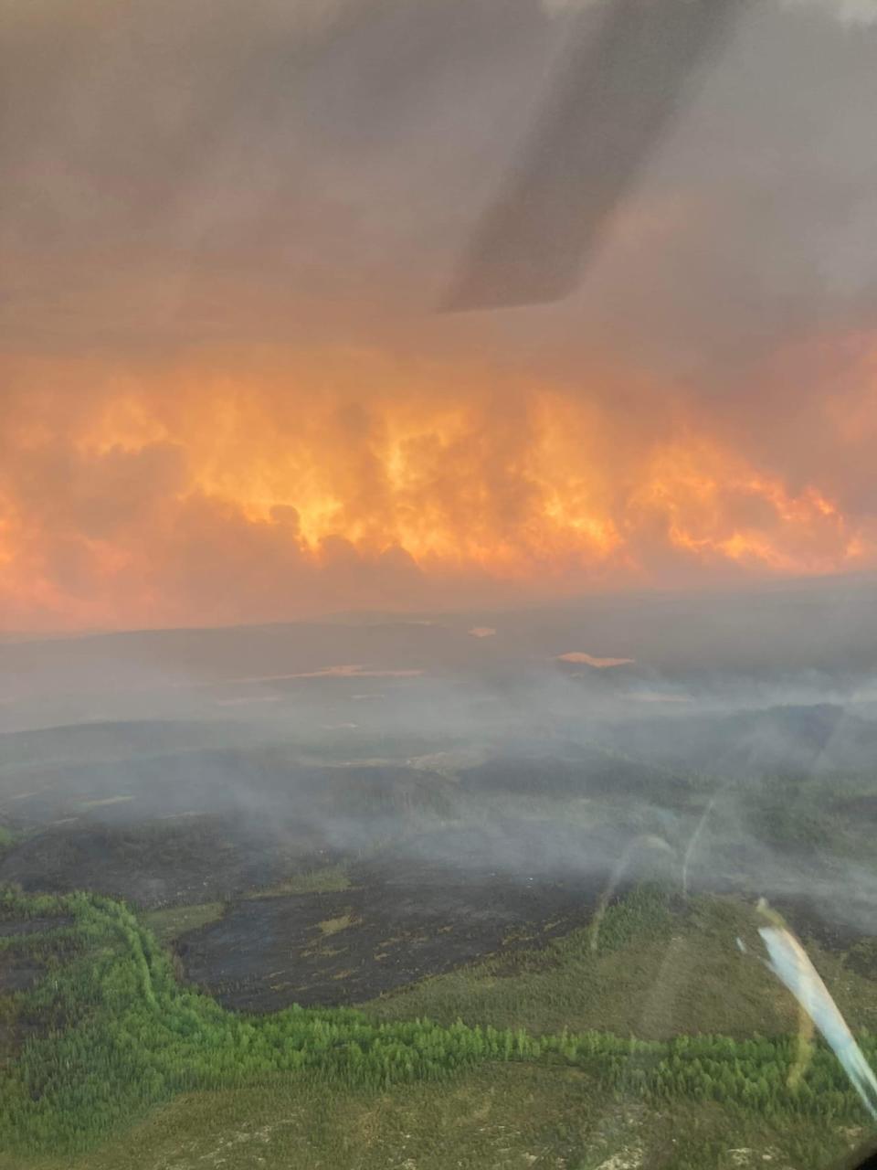 An aerial shot of charred forest and intense flames near Lac Mistassini in the summer of 2023. 