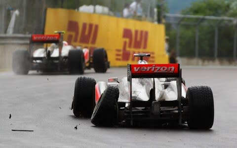 Lewis Hamilton of Great Britain and McLaren suffers damage to his rear left wheel after driving too close to team mate Jenson Button of Great Britain and McLaren in the early stage of the Canadian Formula One Grand Prix at the Circuit Gilles Villeneuve on June 12, 2011 in Montreal, Canada - Credit: Paul Gilham/Getty Images