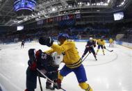 Team USA's Alex Carpenter (25) and Sweden's Lina Wester battle for the puck during the second period of their women's semi-final ice hockey game at the Sochi 2014 Winter Olympic Games, February 17, 2014. REUTERS/Mark Blinch