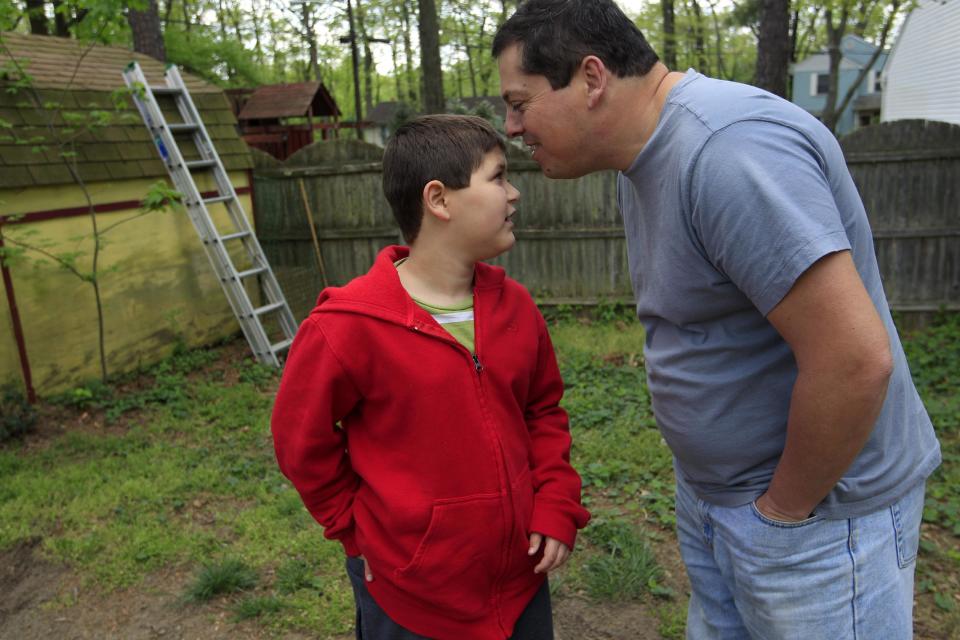 Stuart Chaifetz kisses his son Akian Chaifetz, 10, on the head as they play in the backyard of their home in Cherry Hill, N.J., Wednesday, April 25, 2012. After Chaifetz was told that his son Akian was acting violently at his New Jersey school he decided to investigate. Akian's autism prevented him from being able to explain to his father if anything had been happening to him at school. Chaifetz decided the only way to find out what was behind the outbursts was to send his boy to school wearing a hidden audio recorder. While Akian's teacher and colleagues denied anything out of the ordinary was happening, the recordings Chaifetz listened to told a different story. (AP Photo/Mel Evans)