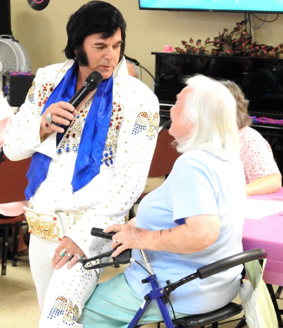 Eric Bressi, known as Elvis' Lost Brother, gets up close and personal with a fan during a performance Wednesday at the Coshocton Senior Center.