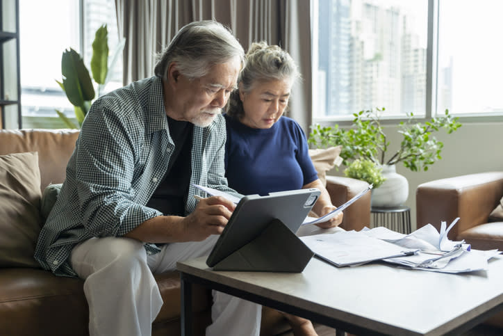 Older couple considers which charitable organizations they will contribute to