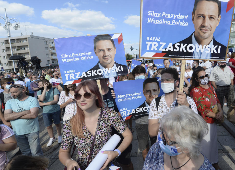 FILE - In this July 4, 2020, file photo, supporters hold banners of Presidential Candidate and Warsaw Mayor Rafal Trzaskowski during a rally in Czestochowa, Poland. Trzaskowski and President Andrzej Duda are heading into a tight presidential runoff that is seen as an important test for populism in Europe. The Sunday, July 12 election comes after a bitter campaign that has exacerbated a conservative-liberal divide in the country. (AP Photo/Czarek Sokolowski, File)