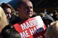 A member of the public holds a placard as Britain's Prince Harry (not pictured) arrives at the Sydney Opera House on May 7, 2015