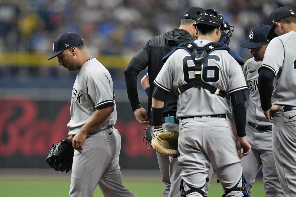 New York Yankees starting pitcher Nestor Cortes, left, is teakne out of the game against the Tampa Bay Rays during the fifth inning of a baseball game Tuesday, June 21, 2022, in St. Petersburg, Fla. (AP Photo/Chris O'Meara)