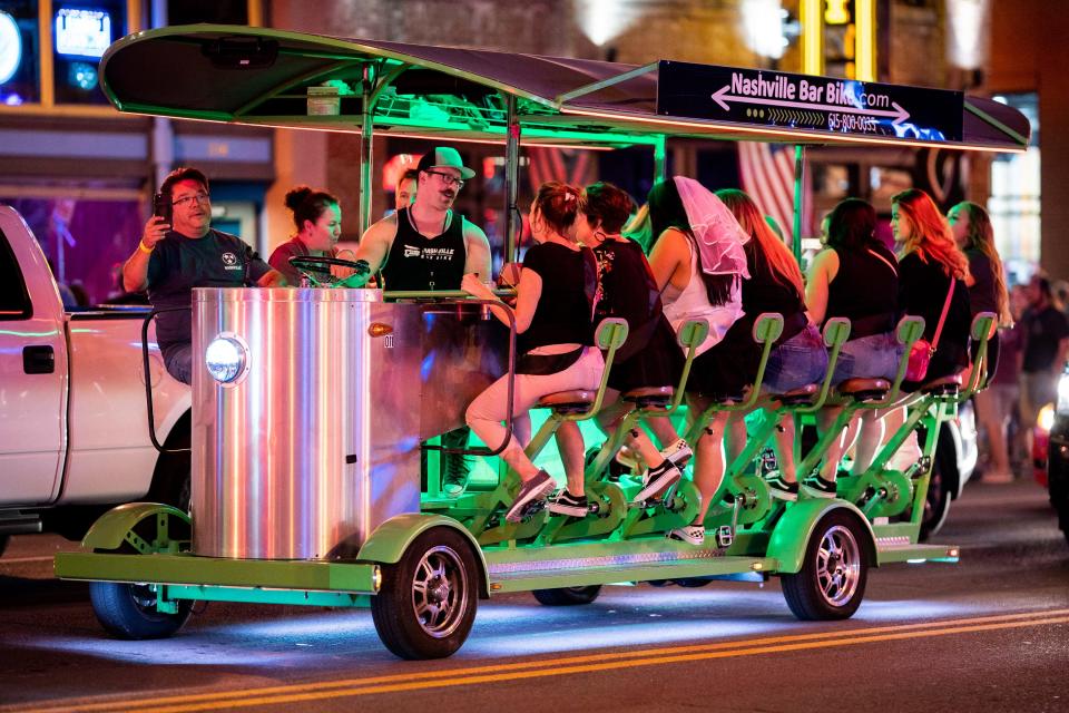 A pedal tavern drives down Broadway in Nashville, Tenn., on Sept. 24, 2021.