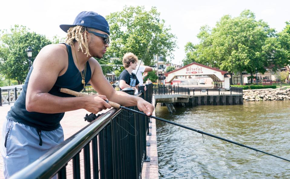 Julien Grotz, left, 16, from Fairless Hills, fishes alongside Jeffrey Spofford, center, 17, from Yardley, in Bristol Borough as the region deals with the latest heatwave on Monday, June 17, 2024.