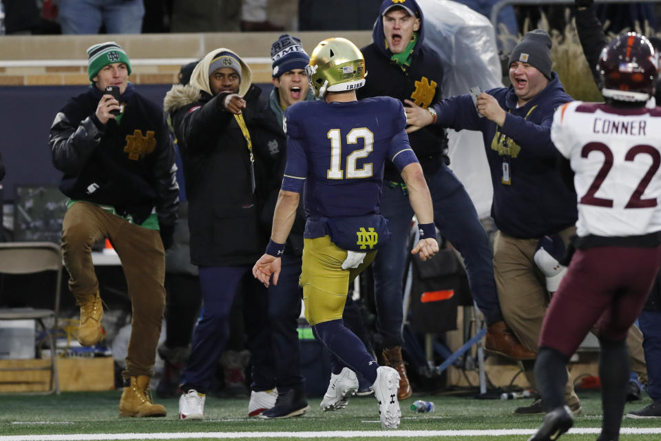 Notre Dame quarterback Ian Book (12) runs into the endzone for a 7-yard touchdown run during the second half of an NCAA college football game against Virginia Tech, Saturday, Nov. 2, 2019, in South Bend, Ind. (AP Photo/Carlos Osorio)